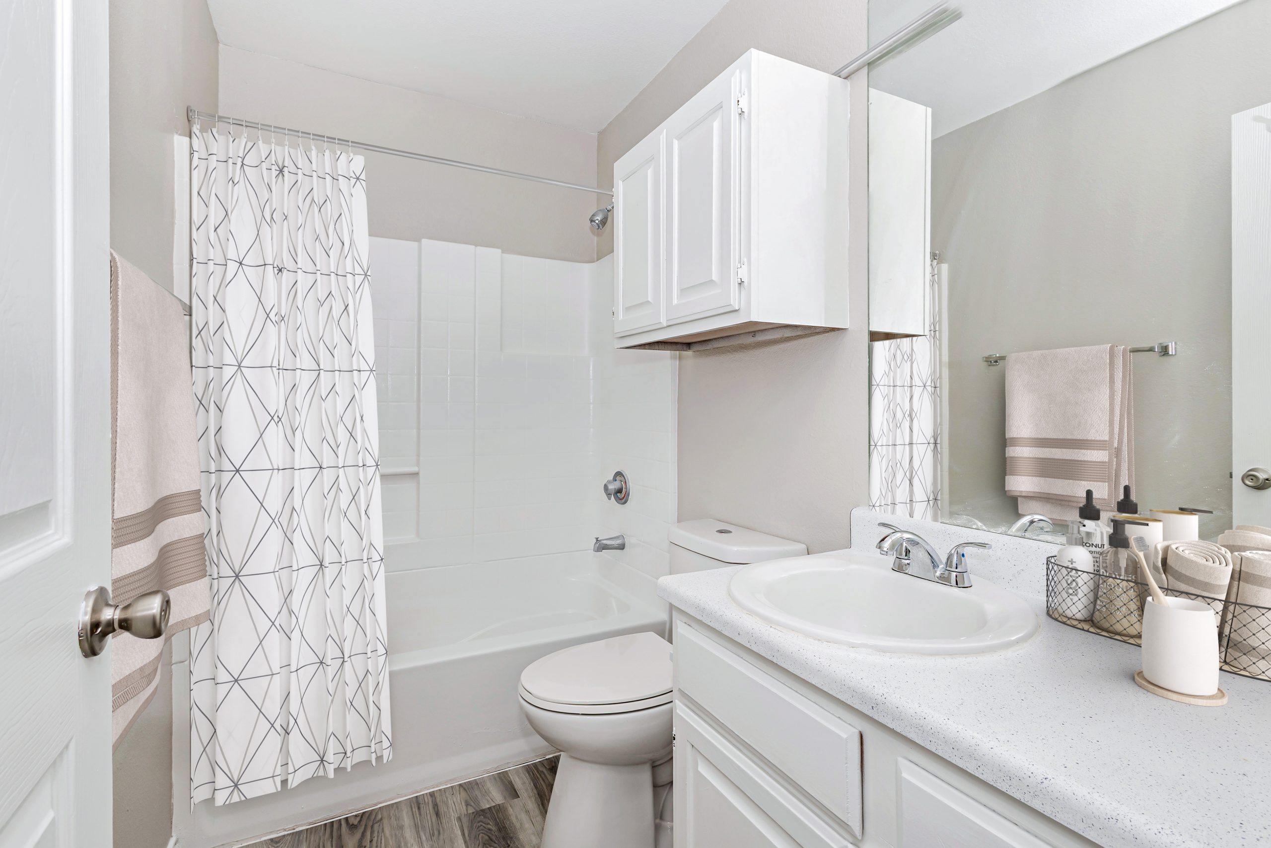 a bathroom with a sink, toilet, and shower